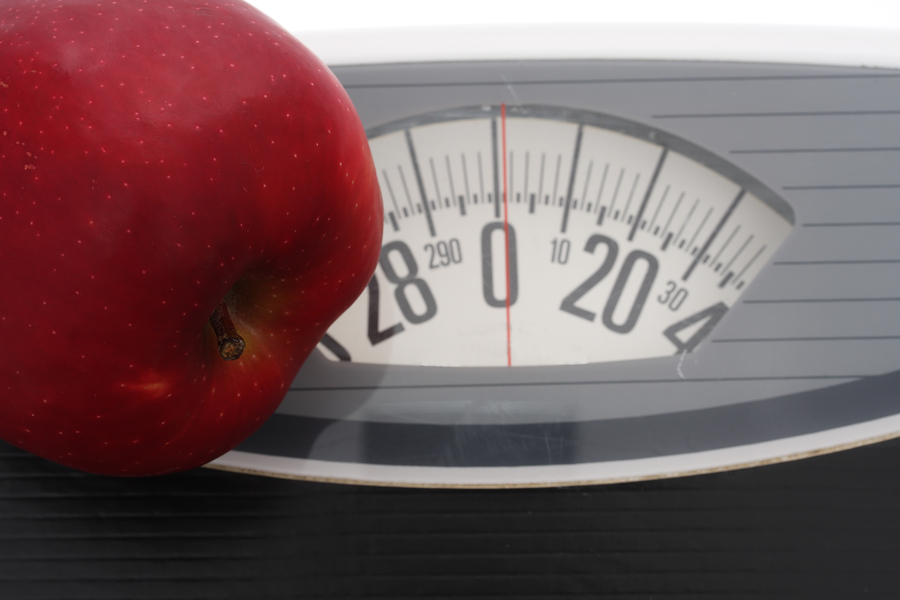 Close up of apple on scales - show healthy living